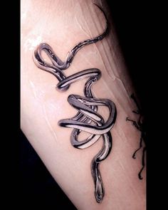 a tattoo on the arm of a person that has a snake in it's hand