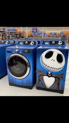 three blue washers with jack skellings painted on them in a store aisle