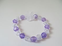 This is a Kids Flower Bracelet. It would make a cute gift for a little girl's Birthday. They make great gifts for party favors. It has a clear flower bead in the middle. It has purple and clear 8mm faceted beads. It was made with .8mm sturdy stretch string. I tie it several times to prevent breakage. It fits girls ages 4-8. It stretches to fit on the wrist. All items are ready to be shipped I do combined shipping. Items ship in 2-5 business days. Check out more items at: http://www.etsy.com/shop Adjustable Purple Charm Bracelet For Birthday, Cute Purple Beaded Bracelets For Birthday, Adjustable Flower Crystal Bracelet For Party, Cute Purple Bracelets For Birthday, Adjustable Flower Shaped Crystal Bracelet For Party, Adjustable Crystal Flower Bracelet For Party, Adjustable Flower-shaped Crystal Bracelet For Party, Adjustable Flower Bracelets For Birthday Gift, Purple Beaded Bracelet For Birthday