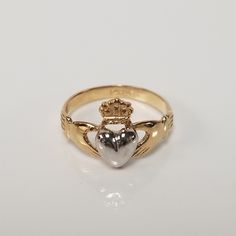 "Thanks for shopping our vintage estate store. We tend to sell well below wholesale and truly hope you enjoy all of our items. Many of the items are one of a kind, so please enjoy scrolling through the pictures and hopefully something will catch your eye. Blacks spots are from camera or reflections. Beautiful estate 14k gold yellow white gold Irish Claddagh infant or baby ring. Retails $299 on sale $149 Ring size: 1 Setting: 3/8\" 8.5mm Band width: 2mm Weight: .1.07 grams Beautiful ring, one tha Classic 14k White Gold Heart Ring, Antique 14k Stamped Rings For Gift, Vintage Rings With Hallmark As Gift, Vintage Rings For Gifts, Classic Polished Heart Ring For Anniversary, Formal Hallmarked Heart Cut Ring, Classic Heart Ring With Polished Finish For Anniversary, Heirloom Hallmarked Rings For Collectors, Collectible 14k Gold Heart-shaped Jewelry