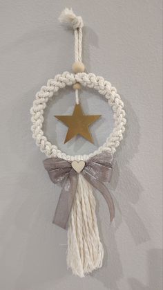 a star hanging from the side of a wall with a tasseled rope around it