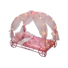 a doll bed with pink sheets and lights on the sides, in front of a white background