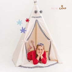 MINICAMP's Off-white Children's Teepee, detailed with grey pom poms, brings style and fun to any play area. Ideal for kids' bedrooms or playrooms, this teepee is crafted from safe, unbleached canvas. While offering a whimsical retreat, it's designed for the chemical-free safety of your child. The matching playmat, sold separately, completes this inviting nook. Perfect for indoor play or outdoor adventures, it’s a hit with parents and kids alike for its blend of whimsy and minimalist chic.