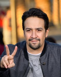 a man making the peace sign with his fingers