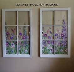 two windows with flowers painted on them in front of a wall that says right up my alley designs