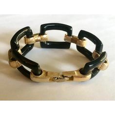 This is part of Chairish’s Costume Jewelry assortment.  This classic Vintage Monet Black Lucite Gold Tone Link Bracelet will make a statement whether you're meeting friends for lunch, running errands or headed out for a night on the town. The five shiny black Lucite links juxtaposed against the interlocking matte gold links elevate the design and make this piece of costume jewelry a standout.  Dimensions: 7.5" Long Condition: Great vintage condition; wear consistent with age. Please see pics for details. Marks: MONET   - About Monet - Have you ever looked at a piece of jewelry, and saw a nice, glittery part that you thought for sure was gold? Well, this is not always the case. Sometimes, it may just look expensive – but in truth, it is only made under a skilled brand. One such example is t Luxury Black Jewelry For Office, Elegant Adjustable Jewelry For Office, Luxury Black Office Jewelry, Elegant Black Jewelry For Office, Elegant Black Office Jewelry, Vintage Black Jubilee Bracelet, Modern Adjustable Evening Bracelets, Chic Rectangular Bracelets For Formal Occasions, Chic Black Bracelets For Formal Occasions