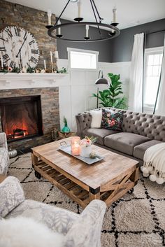 a living room filled with furniture and a fire place in front of a clock on the wall