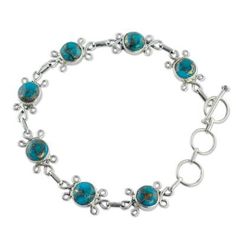 Like flowers blue gemstone hemispheres enclose delicate hints of gold. Neeru Goel's design sets them amid silver petals and joins them with sterling links. The result is a delightful bracelet showcasing composite turquoise. .925 Sterling silver Gift Turquoise Metal Bracelets, Nickel-free Round Turquoise Bracelets, Elegant Round Turquoise Bracelet, Elegant Turquoise Round Bracelet, Elegant Turquoise Sterling Silver Beaded Bracelets, Nickel-free Turquoise Bracelet Jewelry, Elegant Turquoise Beaded Metal Bracelets, Turquoise Metal Bracelet Jewelry, Elegant Nickel Free Turquoise Beaded Bracelets