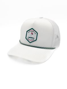 a white trucker hat with a green patch on the front