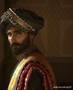 a man in a turban is looking at the camera with an intense look on his face