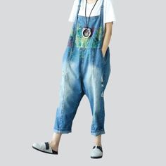 Dare to stand out this 2023 Spring-Summer with our exclusive painted ripped denim jumpsuit. Urban mode personified and textured for the vogue fashionista. this jumpsuit promises to be your wardrobe MVP!Why It's Your Next Vibe EssentialCrafted with the utmost care. this jumpsuit features slouchy fit. suspenders closure. and a painted distressed pattern that adds a unique edge to your look. Premium quality denim ensures a perfect fit. the perfect amount of stretch. and all-day comfort. Plus. the j Distressed Denim Overalls For Spring, Spring Distressed Denim Overalls, Spring Distressed Overall Jeans, Trendy Ripped Jumpsuits And Rompers For Spring, Sleeveless Loose Fit Jumpsuits For Spring, Casual Blue Ripped Jumpsuits And Rompers, Casual Ripped Denim Jumpsuit For Spring, Trendy Denim Blue Jumpsuits And Rompers For Spring, Trendy Distressed Overalls