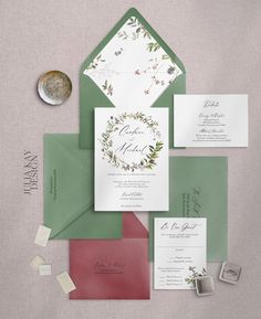 the wedding stationery is laid out on top of each other