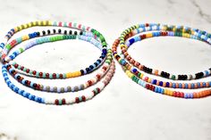 Introducing a beautiful set of random seed bead bracelets, meticulously handmade with love. Inspired by the 'bestseller' summer seed bead bracelets, these bracelets feature tiny beads measuring just 2mm. Perfect for any occasion, these delicate bracelets make a wonderful gift. Embrace the joy of layering bracelets without the heavy or bulky feeling - you'll hardly even notice you're wearing them! The average woman's wrist size is around 7 in When orders are prepared I choose completely random br Everyday Round Beaded Bracelets With 108 Beads, Summer Friendship Bracelets With Spacer Beads, Minimalist Multicolor Round Bead Friendship Bracelets, Minimalist Multicolor Beaded Friendship Bracelets, Minimalist Beaded Bracelets With Spacer Beads For Beach, Minimalist Beaded Bracelets For Beach With Spacer Beads, Minimalist Beaded Bracelets With Spacer Beads, Adjustable Minimalist Multicolor Beads, Minimalist Beaded Bracelets With Tiny Beads For Summer