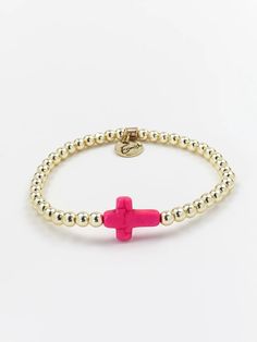 ERIMISH - CROSS SINGLE GOLD/PINK STACK BRACELET INFO Beautifully dainty, the cross bracelet brings all the charm. The classic design made with gold plated beads and a pink cross is perfect for everyday wear and will no doubt become a timeless piece in your collection. Bracelets are 'one size fits most' and are designed to fit wrists up to 7.5" comfortably. Synthetic Stretch Lead & Nickel Free Please be aware that due to the unique and handmade nature of each product, colors, shapes, and bead sizes may vary slightly from the photos and descriptions. Gold Cross-shaped Beaded Bracelets For Gifts, Adjustable Gold Beaded Cross Bracelets, Gold Cross Beaded Bracelets For Gift, Adjustable Pink Cross-shaped Jewelry, Pink Adjustable Cross-shaped Bracelets, Adjustable Pink Cross Bracelet, Pink Cross Bracelet For Gifts, Pink Cross Bracelet For Gift, Erimish Bracelets