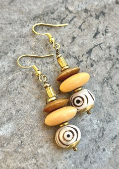 Tribal Boho Earrings African Batik Bone and Brass Beads Bohemian Bone-colored Nickel-free Earrings, Nickel-free Beige Bohemian Jewelry, Bohemian Nickel-free Beige Jewelry, Handmade Bohemian Cream Earrings, Handmade Cream Bohemian Earrings, Bohemian Cream Jewelry With Wooden Beads, Bohemian Brown Beaded Brass Earrings, Bohemian Cream Dangle Earrings, Bohemian Cream Earrings For Beach