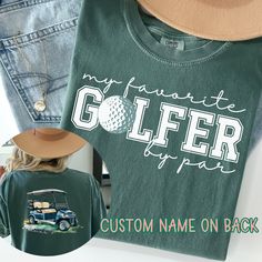 Support Your Favorite Golfer In Our Personalized Golf Mama TShirt, Golf Girlfriend Tee, Golf Mom Shirt, Custom Golf Tshirt, My Favorite Golfer By Par, Golf Tournament Shirt A fan favorite, the Comfort Colors 1717 tee is crafted from medium-weight, high-quality 100% ring-spun US cotton for enduring comfort. Its relaxed fit offers comfort in both casual and semi-formal settings, while the crew neckline provides a timeless, polished look that is perfect for accessorizing. The pre-shrunk fabric guar Team Spirit Cotton T-shirt For Golf, Team Spirit Golf T-shirt For Sports Season, Green Letter Print T-shirt For Golf, Green Graphic Print Golf Top, Green Graphic Print Tops For Golf, Golf T-shirt With Graphic Print For Team Spirit, Green Golf T-shirt With Letter Print, Golf Girlfriend, Golf Mom Shirts