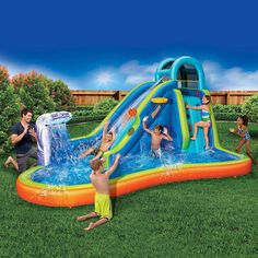 an inflatable water slide with kids playing