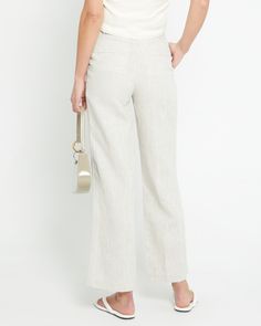 Product Details Introducing the Everyday Linen Pant. Crafted from 100% lightweight linen, this pant offers relaxed, breezy comfort for any occasion. Subtle pleats add shape and style to the effortless design. - Front button- Front zipper- Pockets- Content: 100% Organic Linen Style# C22WPA70018 Fit Notes - Model wearing a size 2- Model measurements: 5'10.5'' Height / 32'' Bust / 25'' Waist / 35'' Hips- Garment measurements: Size Length Waist Hips 0 102,24 68,58 93.98 2 103.19 71.12 96.52 4 104.14 Spring Linen Bottoms For Day Out, Chic Linen Bottoms For Day Out, Chic Linen Tapered Leg Bottoms, Chic Linen Bottoms With Tapered Leg, Elegant Flax Colored Pants For Spring, Elegant Flax Pants For Spring, Elegant Flax-colored Spring Pants, Summer Workwear Pants In Flax Color, Chic Linen Pants For Spring