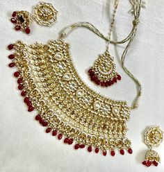 Tyaani inspired Red and Gold Indian / Pakistani Jewellery Set - Choker Necklace and Earrings. Sabyasachi inspired. PACHI KUNDAN (gold plated) We have a large inventory - message us what shade you are looking for or send picture of your outfit to match. Fast shipping - Canada & USA "Life is better ... with a Touch of Elegance". Message for any questions. Chandbali Wedding Jewelry With Motifs, Kundan Sets With Motifs For Wedding, Gold Sets With Motifs For Reception, Red Kundan Sets With Motifs, Red Kundan Wedding Sets, Bollywood Style Jewelry With Motifs For Wedding, Festive Bridal Chandbali Necklace With Motifs, Red Meenakari Temple Jewelry Traditional Wear, Elegant Red Kundan Necklace For Reception