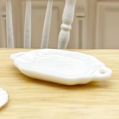 a white plate sitting on top of a wooden table