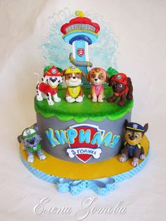 a birthday cake with paw patrol figures on top