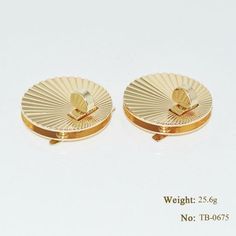 pair of gold plated earrings on white background with words weight 25 6g no tb - 087