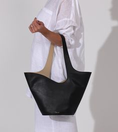 Astrid Tote Bag | Black & Moccasin Totes Cleobella Modern Sculptural Leather Bags, Modern Bucket Bag With Leather Lining, Everyday Use Structured Leather Bucket Bag, Modern Structured Leather Hobo Bag, Chic Structured Leather Hobo Bag, Architectural Structure, Black Moccasins, Trending Handbags, Fall Handbags