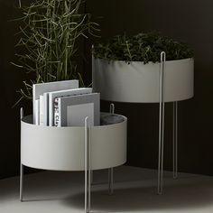 two round planters with books and magazines in them