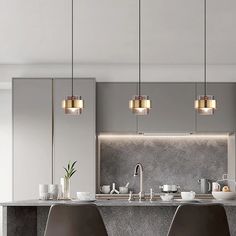 a modern kitchen with two bar stools next to the counter and an island in front of it