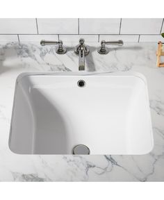 a white sink sitting on top of a marble counter