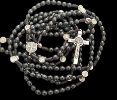 NEW - UNIQUE This is a full rosary which includes all 20 decades or 15 decades by your choice. Its made of a  wood beads. The beads are strung on a strong cord for durability. The center is made of metal medal. The centerpiece is double sided. St. Benedict Crucifix. THE 20 decade ROSARY IS 132 CM (52inches) LONG ! THE 15 decade ROSARY IS 105 CM (41,5inches) LONG ! The beads size 8mm. This is a long rosary and you can use it to pray all four mysteries: Joyful, Luminous, Sorrowful, and Glorious. T Black Wooden Beads Rosary Spiritual Style, Black Wooden Beads Rosary, Black Wooden Beads Spiritual Rosary, Decade Rosary, Saint Benedict, St Benedict, Double Face, Black Wood, Wood Beads