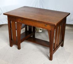 a small wooden table with one drawer on the top and two open shelves below it