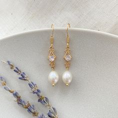 This earrings are a popular choice for bridal parties, they are really stylish and easy to wear. A fabulous piece of wedding jewelry for brides, bridesmaids, and the mother of the bride. FEATURES Pearl Size: 8-9 mm Earring Length:3 cm/1.15'' Material: Natural Freshwater Pearls Finish: 18K Gold Plated Sold as a pair ----------------------------------- ATTENTION Please note that due to the natural origin of freshwater pearls, slight variations in color, size, and shape may occur. These variations add to the unique charm of each pair of earrings. ----------------------------------- PACKAGING A nice gift box is included, ready for gifts. If you have specific requests, please let me know. ----------------------------------- SHIPPING We appreciate every order you place with us. Please keep in mi White Crystal Earrings With Elegant Design For Gift, Elegant Pearl White Crystal Earrings For Gift, Elegant Dangle Crystal Earrings For Gift, Elegant Hypoallergenic Crystal Earrings For Anniversary, Gold Crystal Pearl Earrings For Anniversary, Pearl White Crystal Pearl Earrings For Gifts, Crystal Pearl Drop Earrings As Gift, White Crystal Pearl Earrings Gift, Elegant Gold Crystal Hypoallergenic Earrings