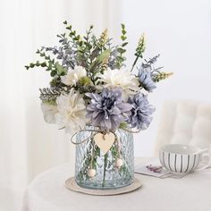 a vase filled with flowers sitting on top of a table