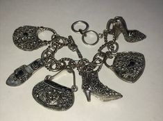 Silver tone Slightly Distressed Purse & Shoe marcasite Toggle charm Bracelet All jewelry has been worn and may show signs of wear. Please see all photos for condition.  Any color change in photos is due to taking photos with and without a flash.  Please see photos as all sales are final. Offers to lower the prices on all my items are welcomed. I do combine shipping so please wait for an invoice if buying more than one item. Fill up a small flat rate priority box or a padded bag for one shipping price of $10.60 USA only! Spend $35.00 and shipping is FREE!  No shipping outside USA.  Display box in photos not included. Thank you for stopping by. 🤗 Elegant Antique Silver Charm Jewelry, Elegant Antique Silver Jewelry With Charms, Elegant Metal Charm Bracelet Collectible, Elegant Metal Charm Bracelet For Collectors, Elegant Silver Vintage Charms, Silver Costume Jewelry Charm Bracelet, Antique Silver Charms With Lobster Clasp, Silver Charm Bracelet In Costume Jewelry Style, Silver Vintage Charm Costume Bracelet