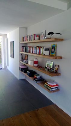 the bookshelves are lined up against the wall