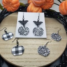 Small white with black pumpkin earrings made with genuine leather.  You have a choice of the white with black laced pumpkins or the black and white plaid pumpkins. The earrings come in stainless steel hardware.  You have a choice of silver, black or black with the wood bat accents. You can also upgrade to sterling silver french hooks (not pictured). Please note patterns may slightly vary depending on where the leather was cut, no two earrings are exactly the same.  Also, note colors may vary dep Plaid Pumpkins, Spooky Earrings, Wood Bat, Black Pumpkin, Small Pumpkins, Earrings White, Stainless Steel Wire, White Plaid