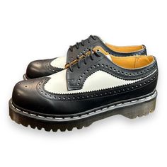 Add A Touch Of Sophistication To Your Casual Look With These Dr. Martens Black White Smooth Leather Wingtip Bex Chunky Oxfords. Made For Men, These Shoes Are Size 7 And Feature A Comfortable Loafer Style. The Black Color Of The Leather Upper Material Complements The White Smooth Wingtip Design And Chunky Sole. The Brand Is Well Known For Its Quality Products And This Pair Of Shoes Is No Exception. Perfect For Any Casual Occasion, These Shoes Are A Must-Have For Any Fashion-Conscious Man. Retro Black Wingtip Oxfords, Retro Black Oxfords With Leather Sole, Retro Black Oxfords For Derby, Black Leather Retro Oxfords, Chunky Sole Shoes, Chunky Oxfords, Mens Platform Shoes, White Dr Martens, Conscious Man