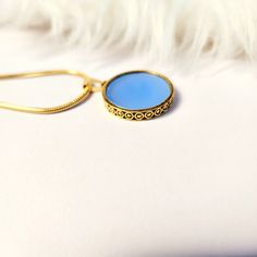 Chalcedony pendant necklace gold,round,blue,flat pendant,gift for her,women jewelry,aqua,gemstone,unique,simple,18k gold,vintage style  necklace size:18" pendant diameter:25mm Thickness:3mm Add this beautiful chalcedony ocean blue pendant gold  necklace. This pendant is inspired by vintage jewellery. Sets well around the neck and looks amazing. Blue Round Pendant Jewelry, Tarnish Resistant, Gold Plated Necklaces With Gemstone Round Pendant, Gemstone Round Necklace Gift For Her, Gold Plated Gemstone Round Pendant Necklace, Gold Plated Necklaces With Round Gemstone Pendant, Elegant Blue Necklace With Coin Pendant, Gold Plated Coin Pendant Jewelry, Circular Delicate Chain Jewelry Gift, Circular Delicate Chain Jewelry For Gifts