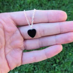 "Beautiful black onyx necklace with a small heart shaped stone. This heart crystal necklace features an all natural stone that has been polished to a smooth and glossy finish. Each onyx pendent includes a wire wrapped bail and suspends from a 14.5 (choker), 15\" (choker), 16\" or 18\" inch chain in your desired material in shiny silver, gold, or stainless steel. Wear this heart necklace as a symbolic reminder of love, as a jewelry piece from nature, for this stone's energy healing properties, or Black Pendant Jewelry With Heart Charm, Black Heart Charm Pendant Jewelry, Black Heart-shaped Jewelry, Minimalist Black Heart Necklace For Valentine's Day, Minimalist Black Heart Charm Necklace, Minimalist Black Heart Necklace, Black Jewelry With Heart Charm Pendant, Black Jewelry With Heart Charm, Black Heart Beads Jewelry For Valentine's Day