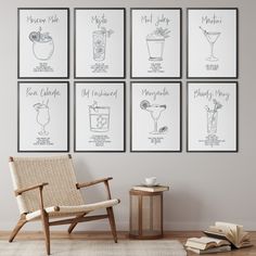 a set of four framed cocktail menus on a wall above a wicker chair