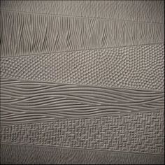 the textured wallpaper is white and has wavy lines on it's surface