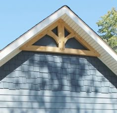 the top of a house with a roof made out of wood and shingles on it