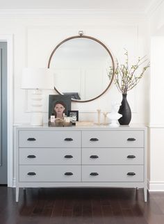 a white dresser with a mirror on top of it and an instagram button below