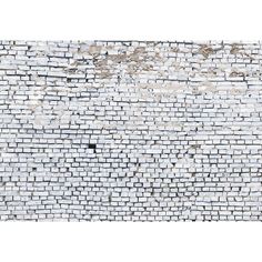 an old brick wall with white paint on it