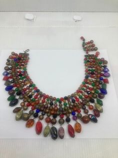 In very good vintage condition...Signed Trifari on the clasp. Beads are in lucite, few bigger are in glass.  Necklace measure 14-15" long, and fringe mesure 3" long! Mo missing beads! We ship only with tracking number and insurance, but we refund overcharged fees. Handmade Vintage Multicolor Beads, Gems, And Cabochons, Vintage Multicolor Necklaces With Colorful Beads, Vintage Multicolor Beaded Necklaces, Vintage Style Polished Beads Necklace, Vintage Multicolor Beaded Jewelry, Vintage Multicolor Jewelry With Large Beads, Vintage Multicolor Large Beads, Vintage Multicolor Round Beads, Vintage Multicolor Faceted Beads Necklace