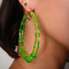 14k yellow gold over sterling silver XL acrylic bamboo hoops in lime green. Our classic 90's Bamboo hoop is now even larger! The XL Bamboo acrylic Hoop is 3 inches in diameter and is a must have for a dramatic, fun look. Our bamboo earrings feature a 14k gold over sterling silver u-bar. The glass-like acrylic makes these hoops shine. Green Hoop Earrings For Spring, Green Small Hoop Earrings For Spring, Green Small Hoop Earrings For Summer, Small Green Hoop Earrings For Summer, Trendy Small Hoop Green Earrings, Trendy Green Hoop Earrings For Spring, Trendy Small Hoop Earrings In Green, Trendy Green Hoop Earrings, Trendy Green Small Hoop Earrings