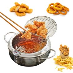 some fried food is being cooked in a pot with chopsticks and onion rings