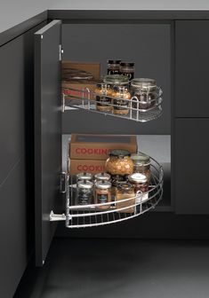 an open cabinet in a kitchen with spices and condiments