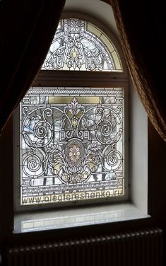 a stained glass window in the corner of a room